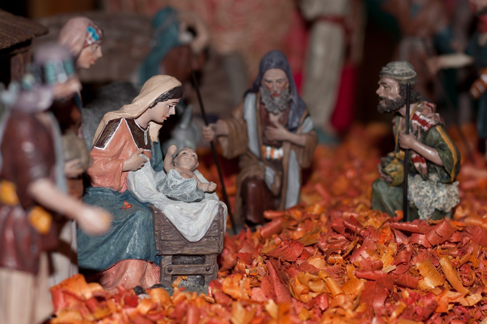 Shepherd santons kneeling before the manger in a Provençal Christmas nativity scene