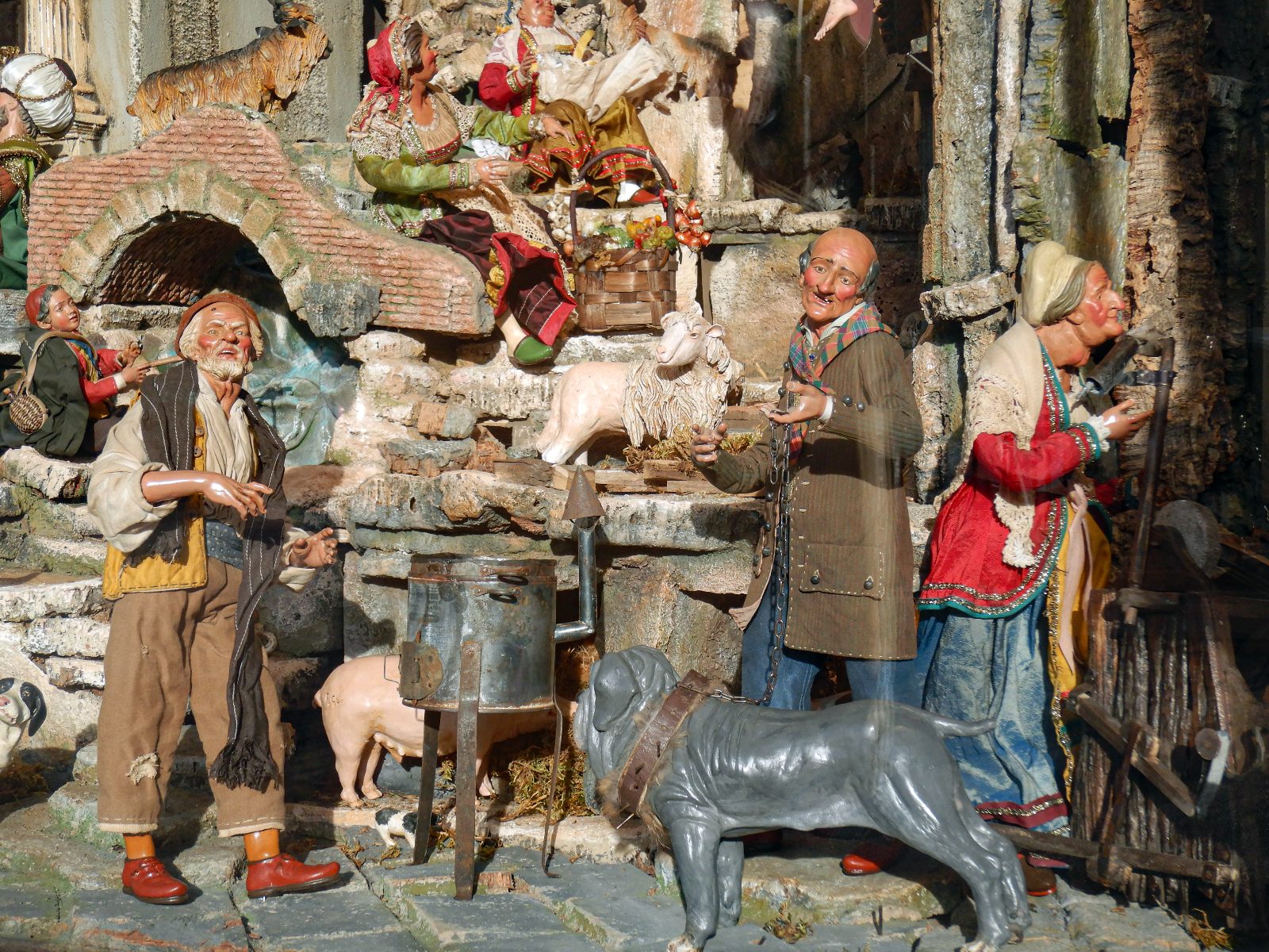 Escena cotidiana en un presepe napolitano: comerciantes, animales y casas de toba